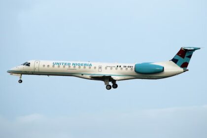 United Nigeria Airlines Embraer ERJ-145LR (registration 5N-BWY) in flight against a clear sky, © Trevor Mulkerrins.