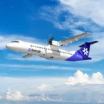 SUM Air Aircraft flying with its blue and white livery against a background of a blue sky with white clouds