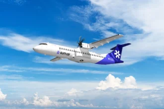 SUM Air Aircraft flying with its blue and white livery against a background of a blue sky with white clouds