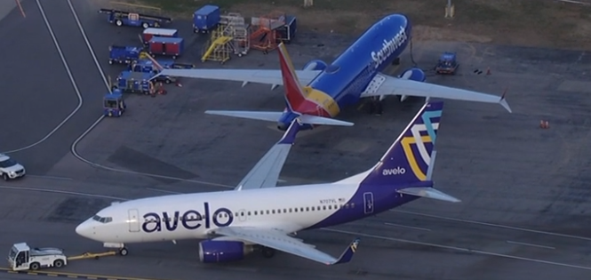 Avelo Airlines Boeing 737 being towed at Raleigh-Durham International with Southwest's Boeing 737 in the backgound © ABC 11 News