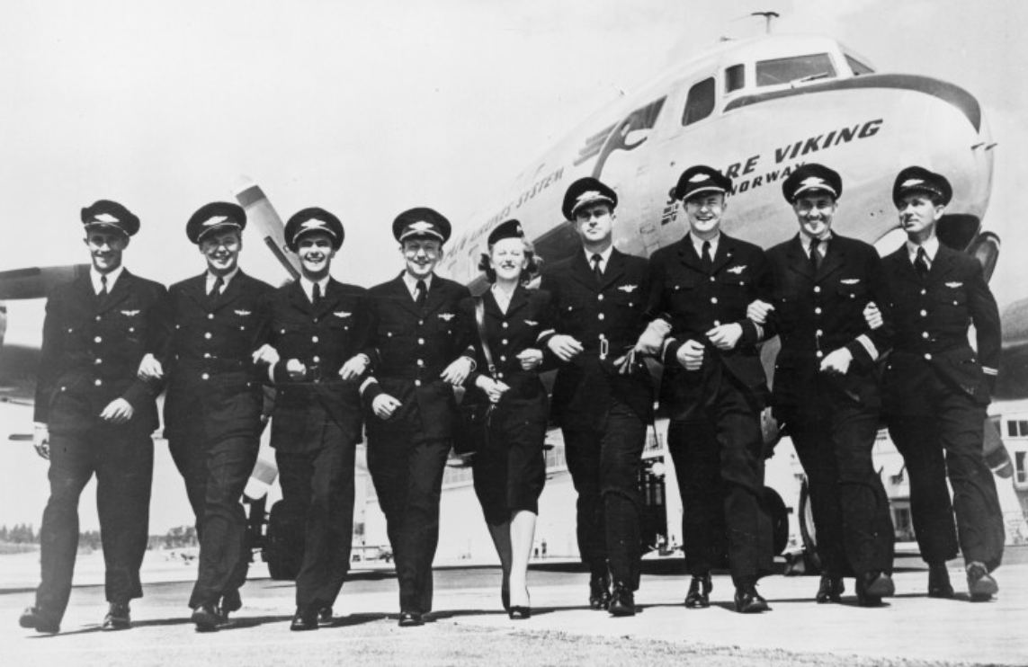 Group portraits at the airport in front of Sverre Viking DC-6 1955. SAS