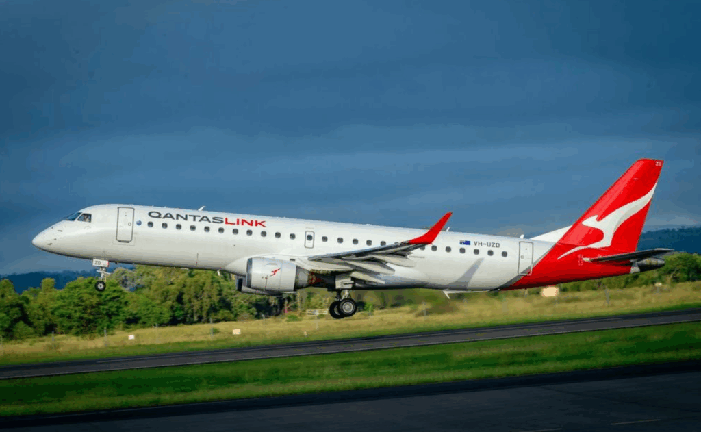 QantasLink taking off from runway.