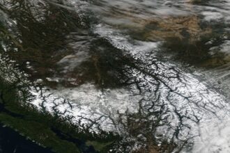 Satellite image of snow-covered regions in British Columbia and Alberta illustrating severe winter weather, linked to Canada flight disruptions, flight delays Canada, and flight cancellations Canada.