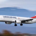 Turkish Airlines 737-800 landing, captured with a blurred background that conveys motion.