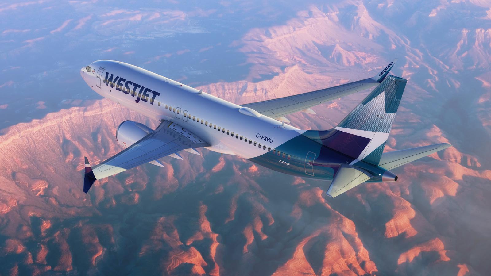 High-angle aerial view of a WestJet Boeing 737 MAX 8 aircraft in its modern blue and teal livery, flying over a vast, sunlit canyon landscape. The plane is banked slightly to the left, showing its registration C-FXWJ