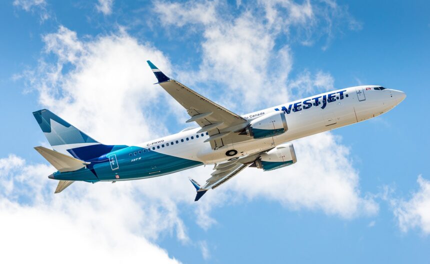 A low-angle view of a WestJet Boeing 737 MAX 8 climbing into a bright blue sky filled with white, fluffy clouds. The aircraft displays the modern WestJet livery, featuring a white upper fuselage with teal and dark blue accents toward the rear and tail. The registration C-FNWD is visible on the fuselage, and the plane's gear is retracted as it ascends.