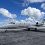 Aery Learjet on the ground, with blue sky in the background