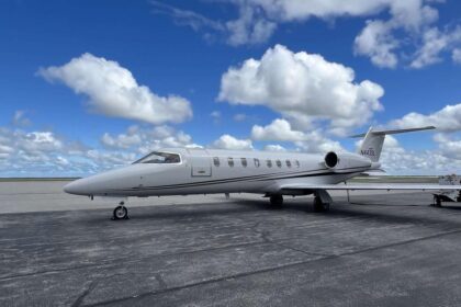 Aery Learjet on the ground, with blue sky in the background