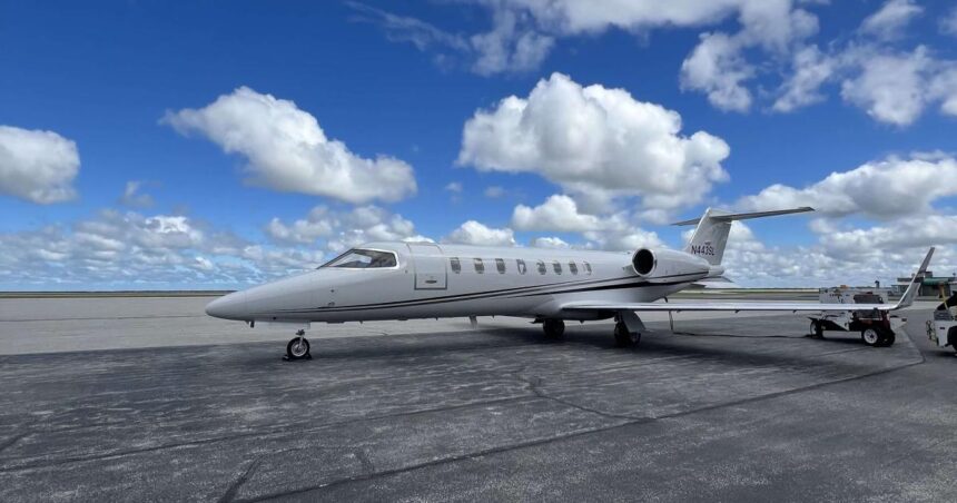 Aery Learjet on the ground, with blue sky in the background