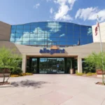 Allegiant Air headquarters building under clear blue skies, with the company’s signage visible on the exterior.