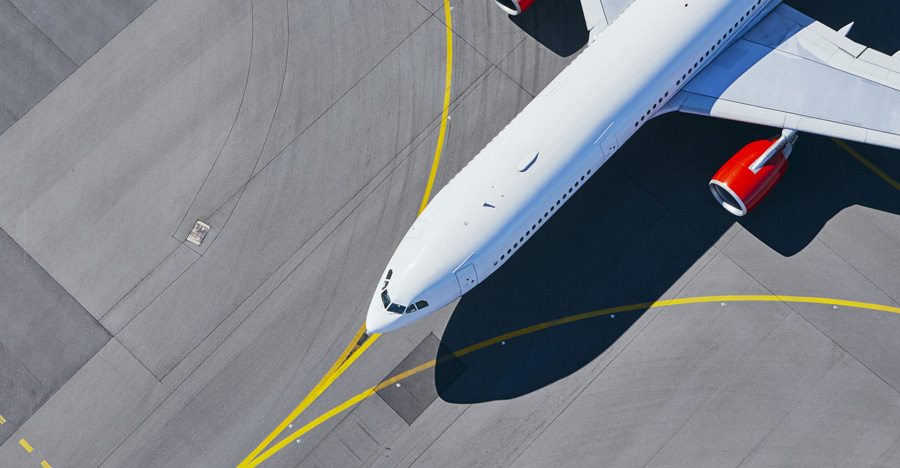 An image of a plane on the run-way taken from above