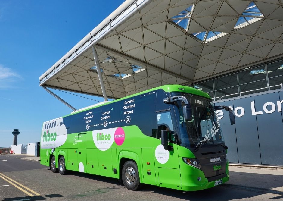 Green Flibco coach in front of London Stansted Airport 