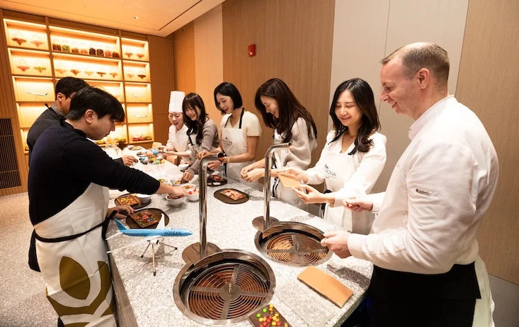 People cooking in the Interactive Culinary Experiences at the Cooking Studio L'atelier