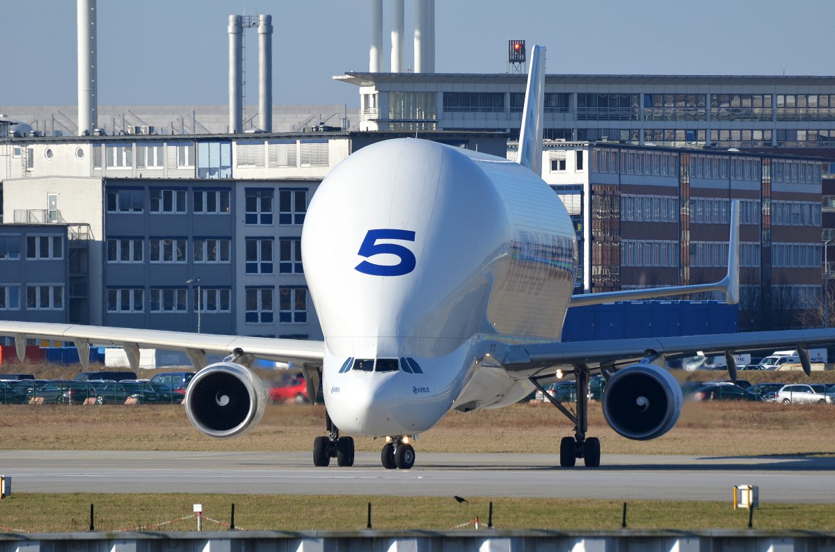 An Airbus A300-600ST on the ground in an industrial area.