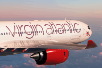 Virgin Atlantic aircraft flying, sunset background.