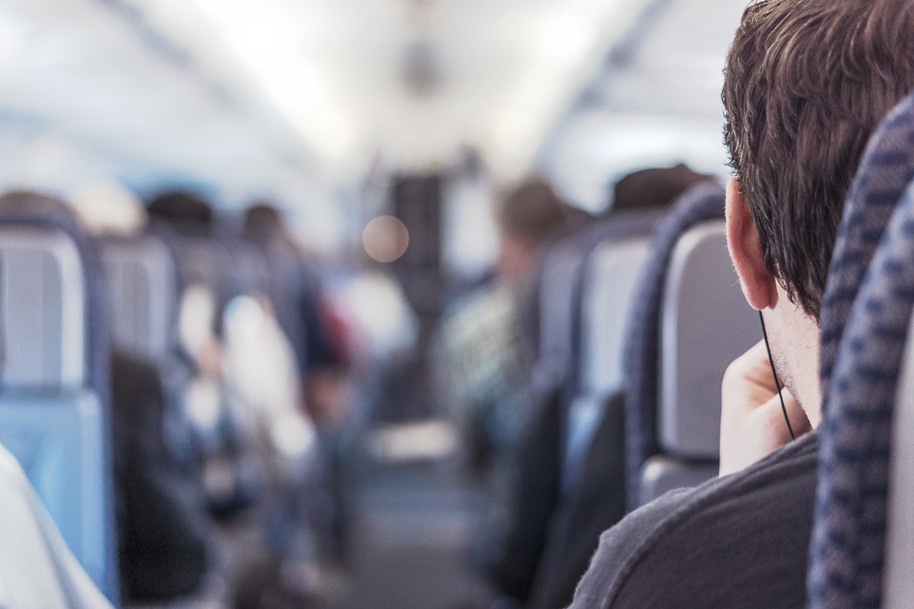 Passenger seated inside a narrowbody aircraft cabin during a flight