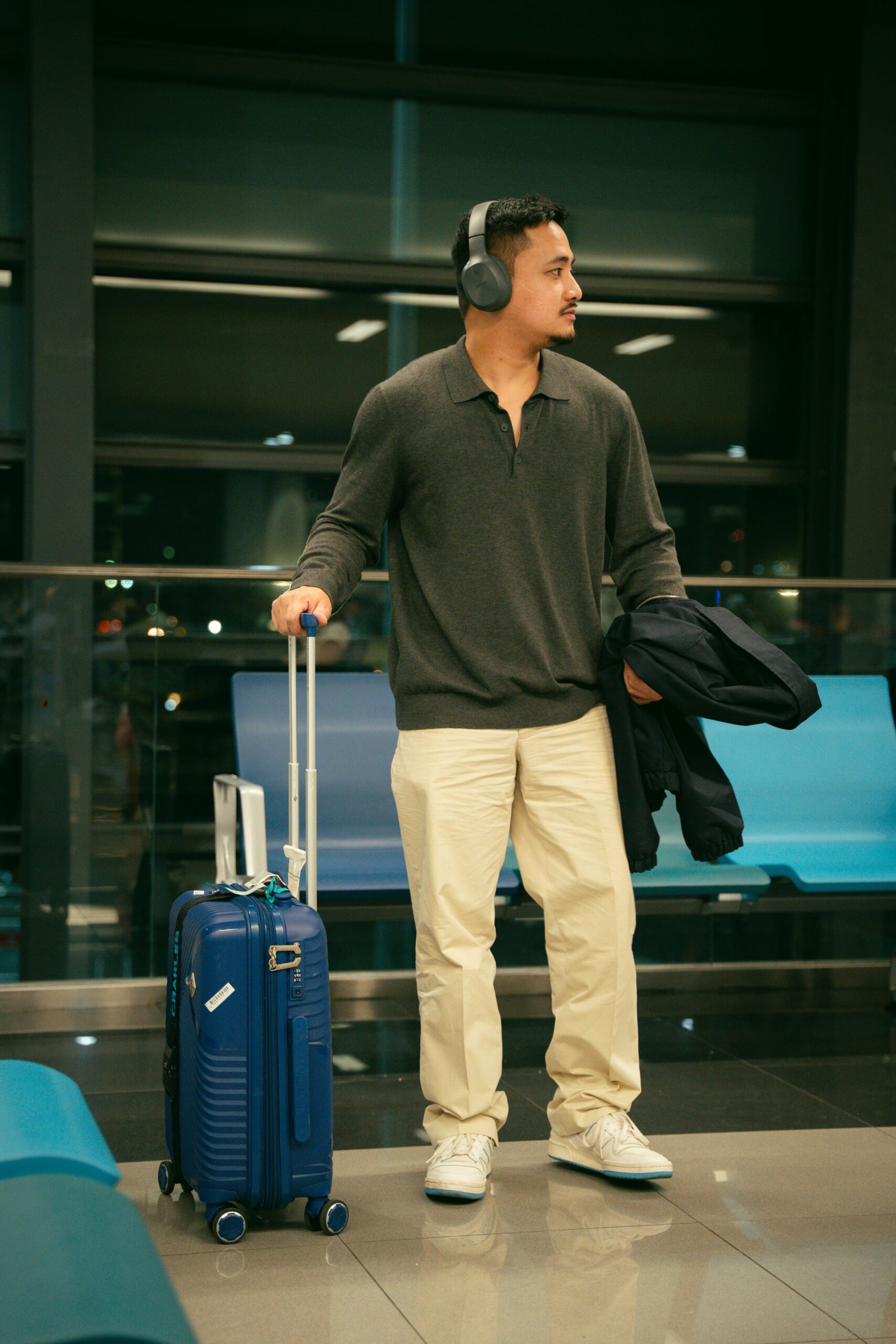 Traveler with luggage at airport terminal
