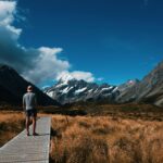 Person Looking at Snow Covered Mountain