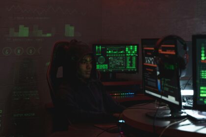 A hacker sat in front of screens