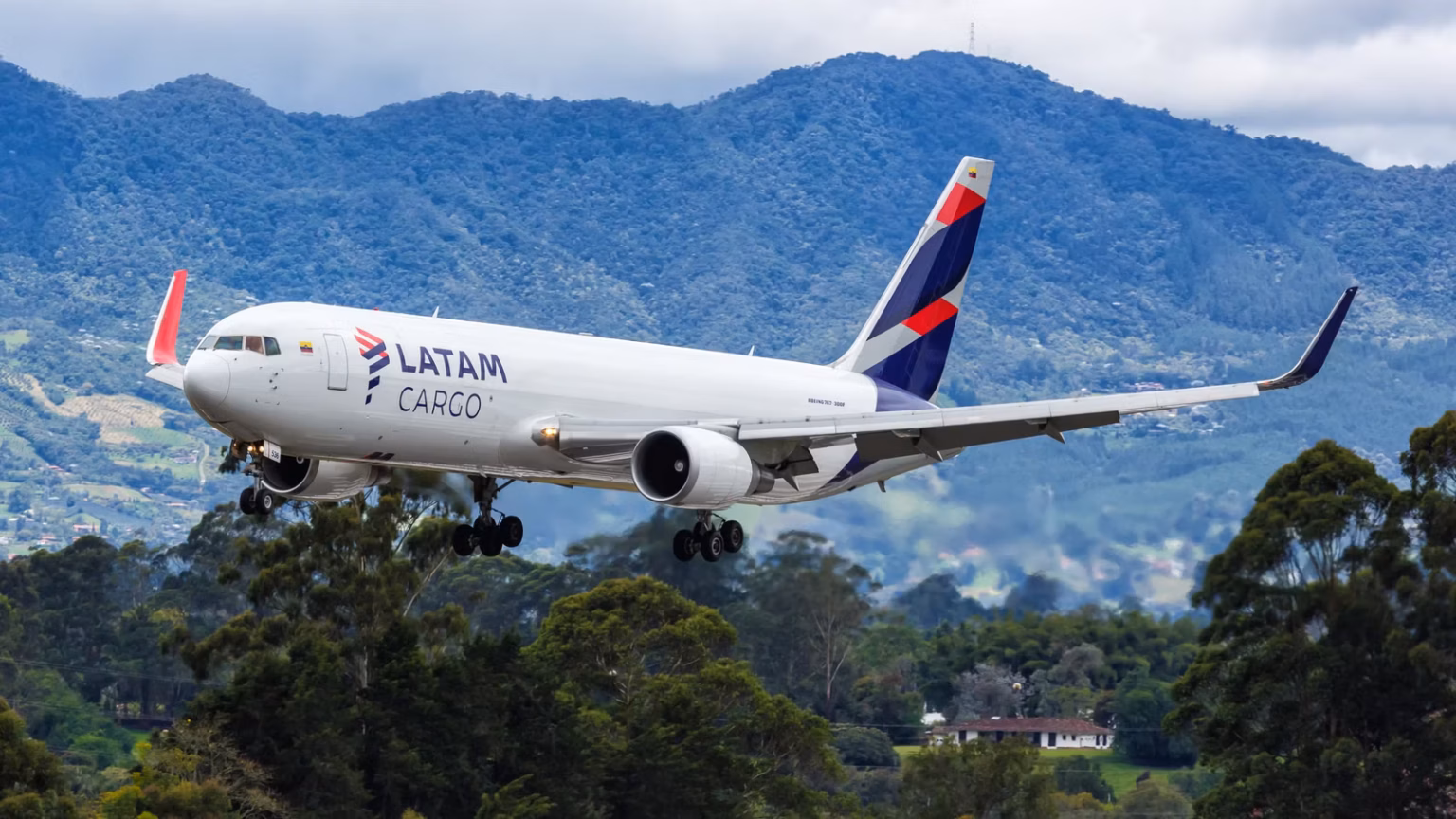 A LATAM Cargo Boeing 767-300 freighter aircraft in a low position.