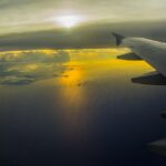 Aircraft wing over the ocean at sunset illustrating China sustainable aviation fuel, Topsoe SAF, SAF production China, China SAF production capacity expansion, and sustainable aviation fuel projects in China.