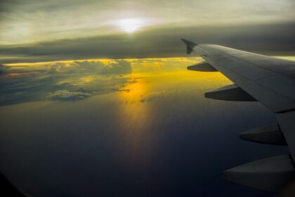 Aircraft wing over the ocean at sunset illustrating China sustainable aviation fuel, Topsoe SAF, SAF production China, China SAF production capacity expansion, and sustainable aviation fuel projects in China.