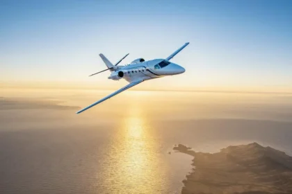 Citation Ascend business jet flying close to a shoreline.