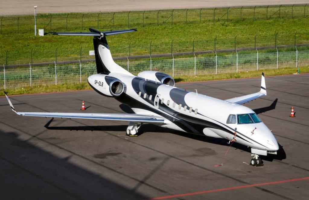 A business jet at Eindhoven Airport, on the tarmac, with grass in the background.