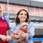 Pets in Cabin - owner holding her dog, next to a cabin crew member