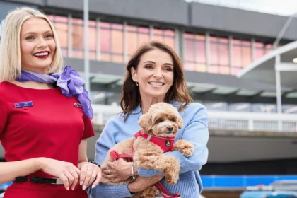 Pets in Cabin - owner holding her dog, next to a cabin crew member