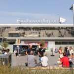 Passengers on forecourt in front of Eindhoven Airport.