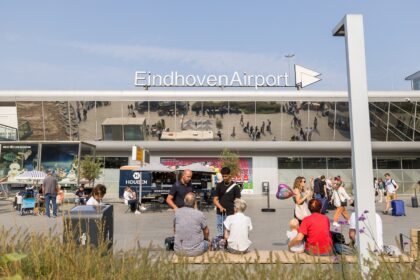 Passengers on forecourt in front of Eindhoven Airport.