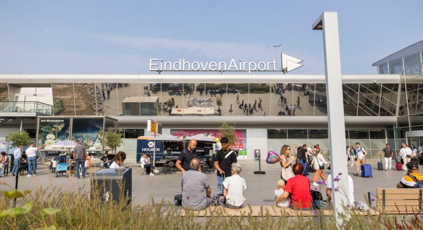 Passengers on forecourt in front of Eindhoven Airport.