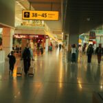 Lotnisko Chopina Warszawa (WAW) airport inside, with a few people walking.