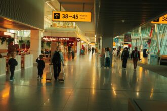 Lotnisko Chopina Warszawa (WAW) airport inside, with a few people walking.