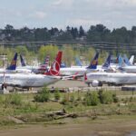 Boeing 737 aircraft grounded, green shrubbery, Turkish Airlines.