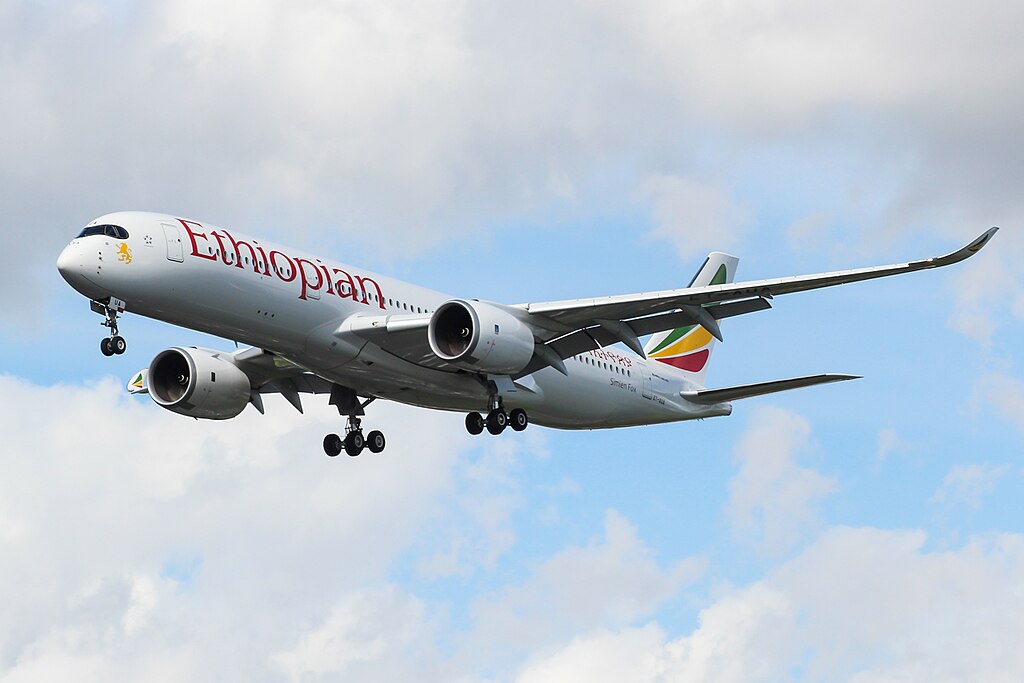 An Ethiopian Airlines A350 flying in a cloudy sky. 
