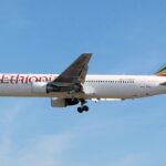 Ethiopian Airlines Boeing B767-300ER flying in blue sky, with the landing gear down.