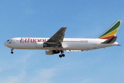 Ethiopian Airlines Boeing B767-300ER flying in blue sky, with the landing gear down.