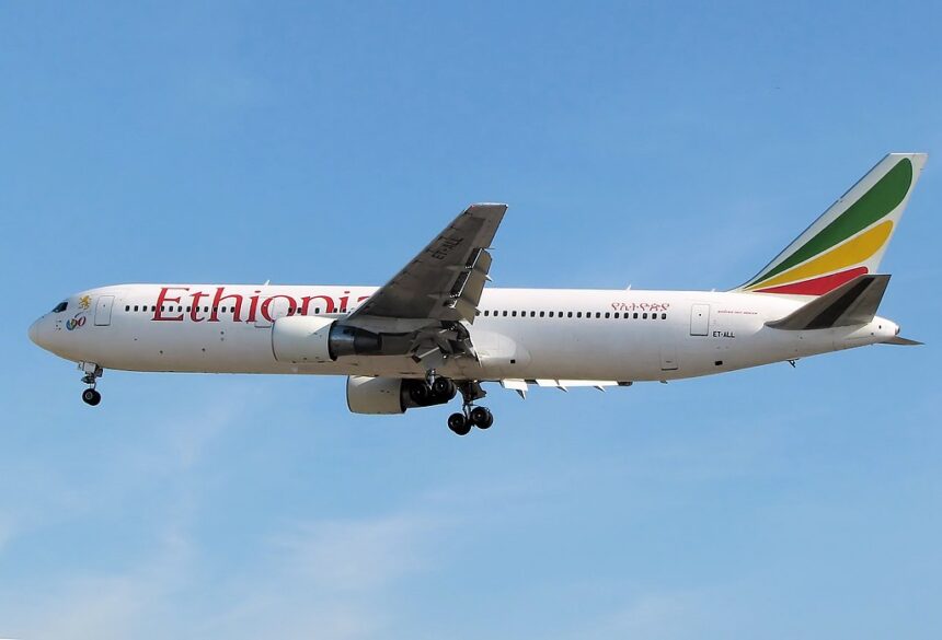 Ethiopian Airlines Boeing B767-300ER flying in blue sky, with the landing gear down.