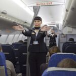 flight attendence performing safety demonstration