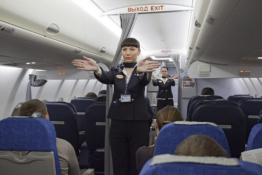 flight attendence performing safety demonstration