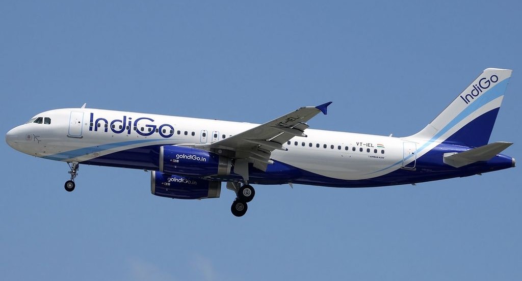 Indigo Airbus aircraft flying in the blue sky.