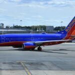 The image shows an aircraft taxiing at the airport