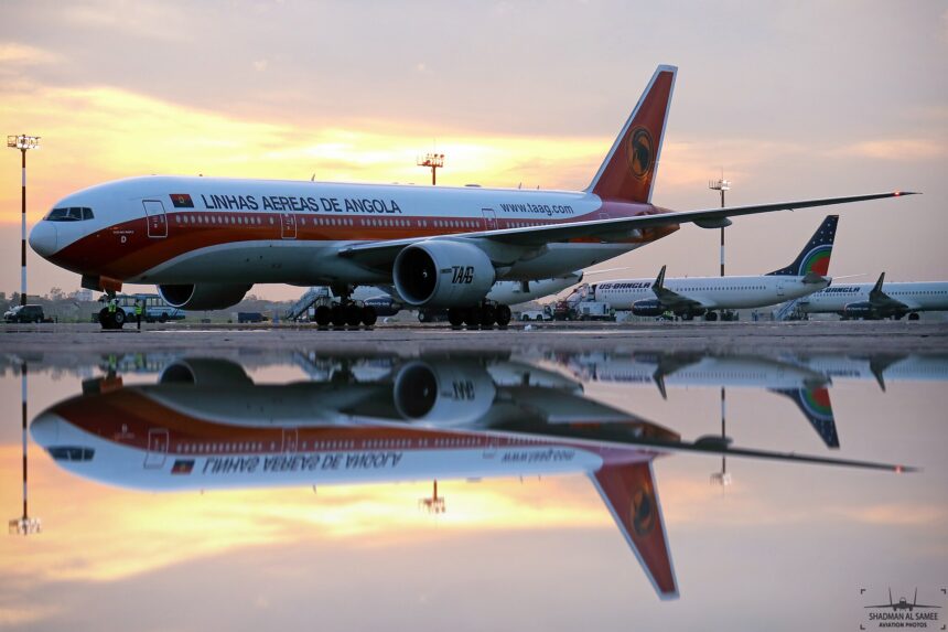 TAAG aircraft on the tarmac, sunset in the background.