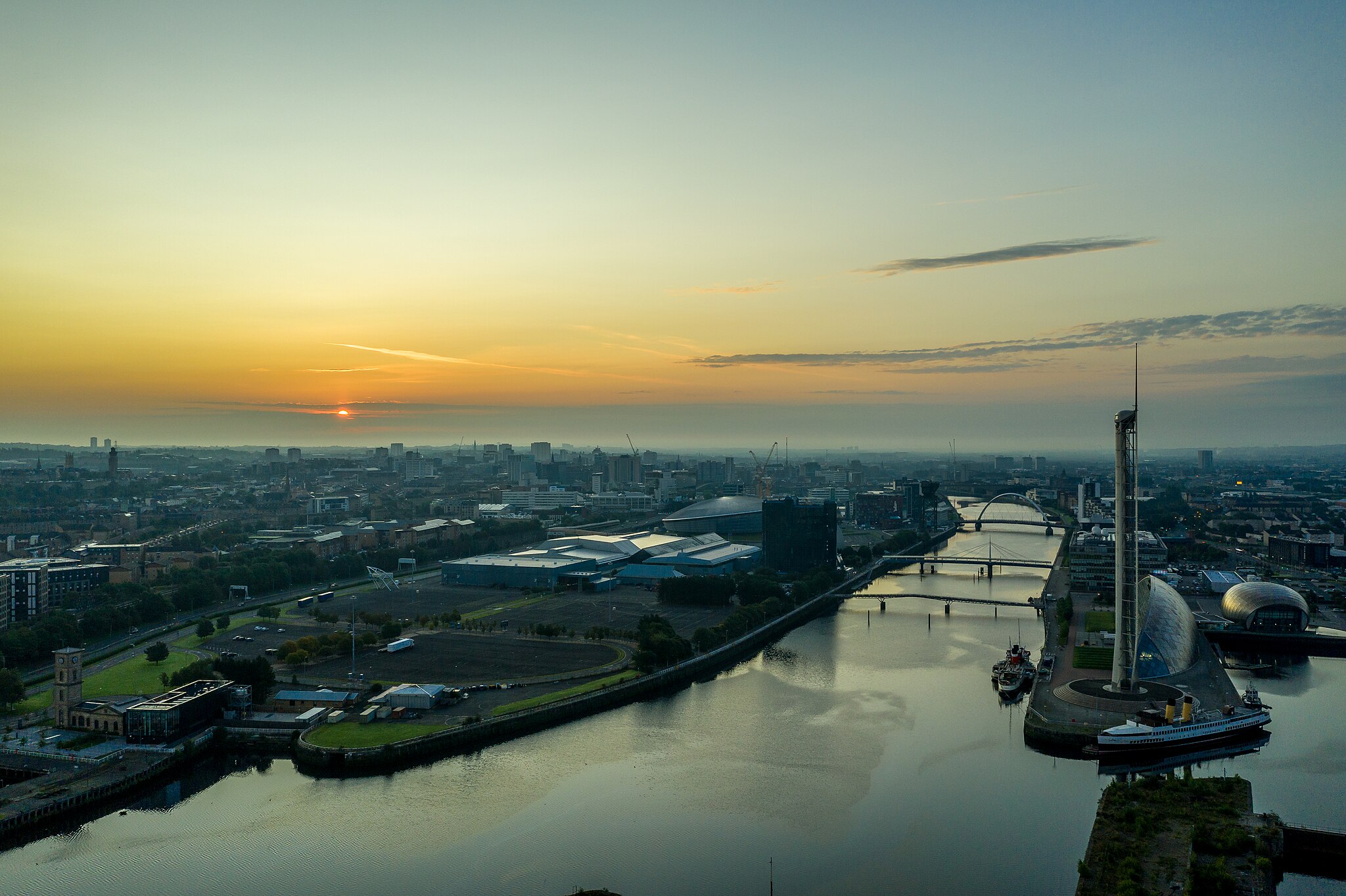 A view of Glasgow's skyline at sunset, with the bridges over the river Clyde in the centre.