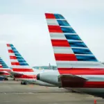 The tails of American Airlines aircraft, displaying the American flag.