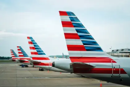 The tails of American Airlines aircraft, displaying the American flag.