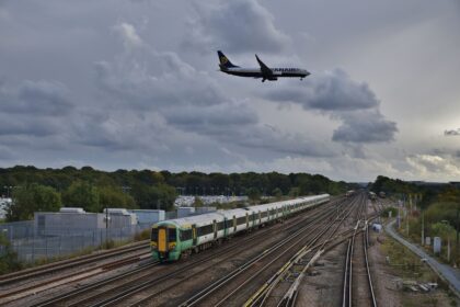 As a Ryanair Boeing 737-800 passes over on final approach, 377424 departs Gatwick Airport at the rear of 1J78 14:36 Victoria - Horsham & Bognor Regis.