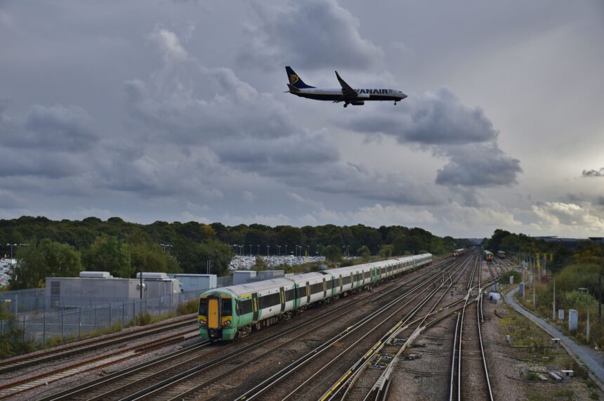 As a Ryanair Boeing 737-800 passes over on final approach, 377424 departs Gatwick Airport at the rear of 1J78 14:36 Victoria - Horsham & Bognor Regis.